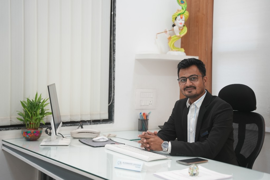 CA Kunwarr Diggaa at his office desk with nameplate and professional setting